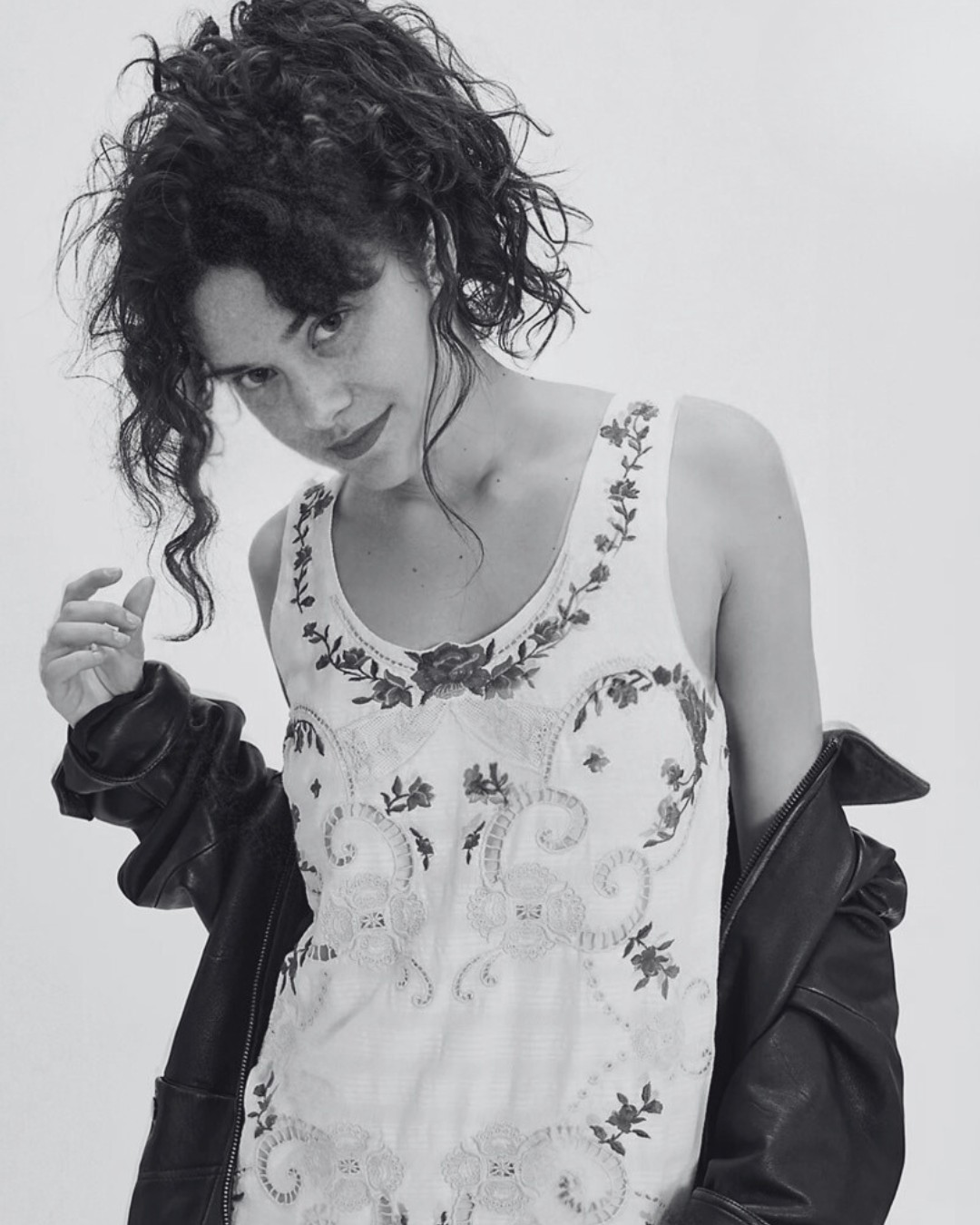 Editorial fashion portrait photographed by Jenna Brooke featuring model in embroidered mini dress with leather jacket.