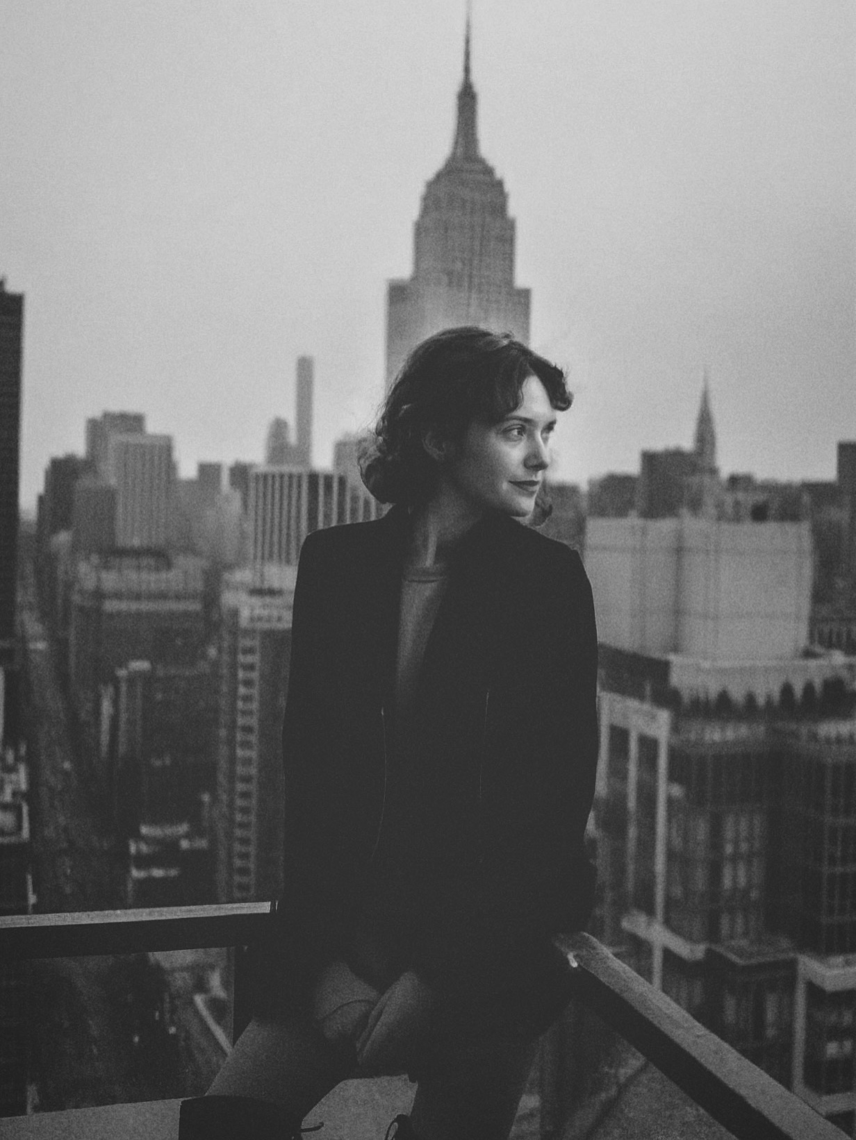 Editorial black and white portrait by Jenna Brooke featuring model with New York City skyline and Empire State Building in the background